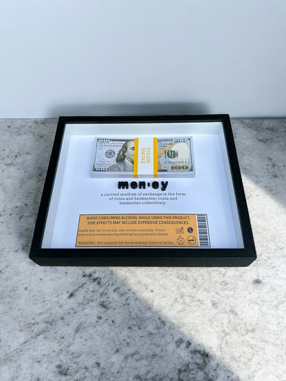 Handmade shadow box with the dictionary definition of money and prop bills