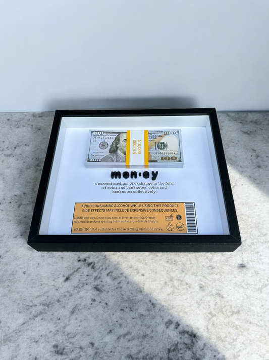 Handmade shadow box with the dictionary definition of money and prop bills