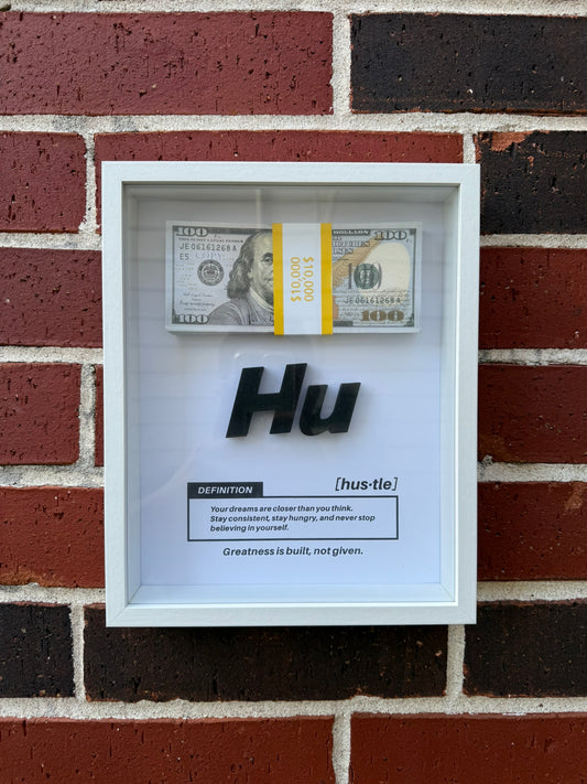 Handmade Hustle definition shadow box with a banded stack of prop bills