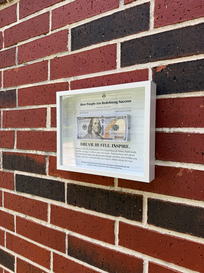 Handmade shadow box styled like a newspaper feature on success with prop bills